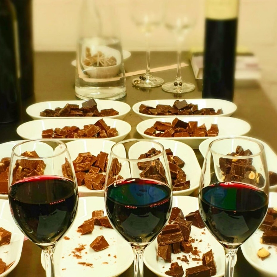 Wine glasses and chocolate on the table for the Chocolate and Wine Workshop